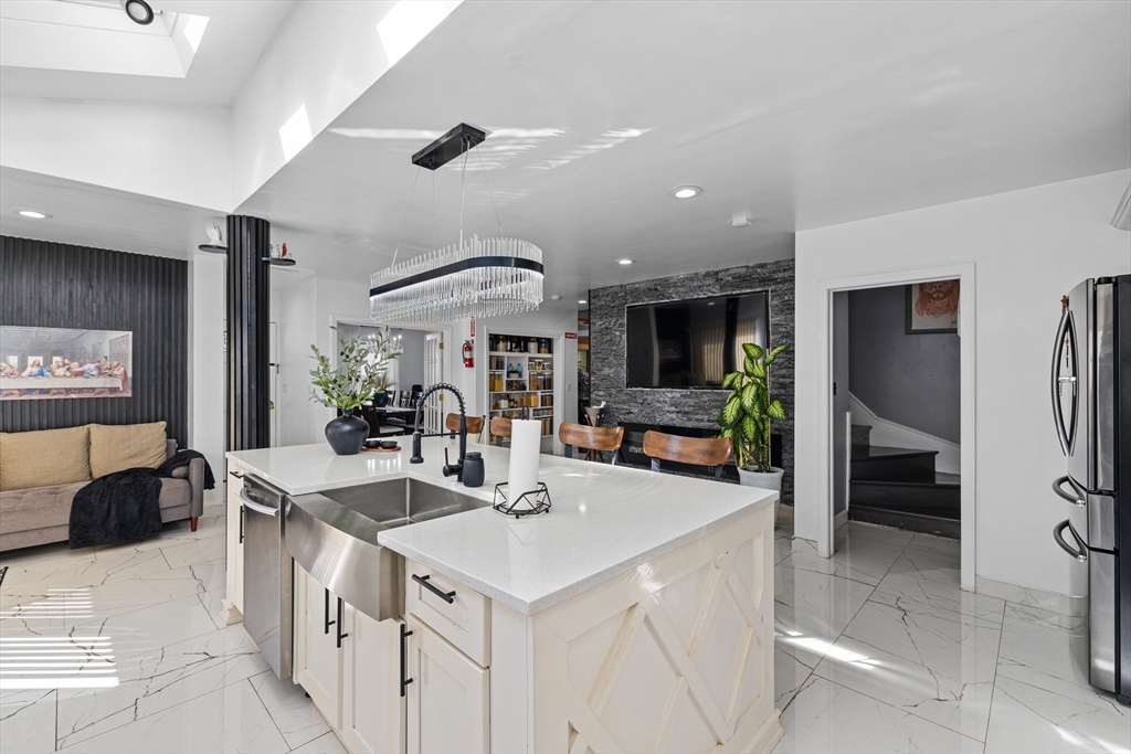 499 Madison Street Fall River, MA 02720 - Photo 14 of 38 a kitchen with stainless steel appliances kitchen island granite countertop a sink and a refrigerator
