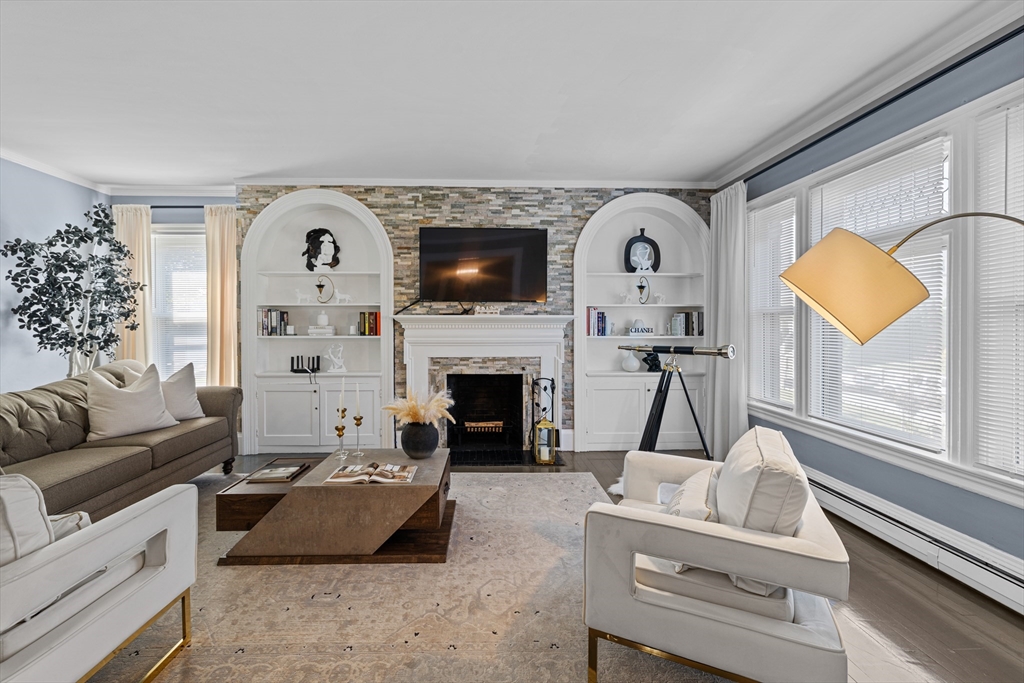 499 Madison Street Fall River, MA 02720 - Photo 18 of 38 a living room with furniture a fireplace and a flat screen tv