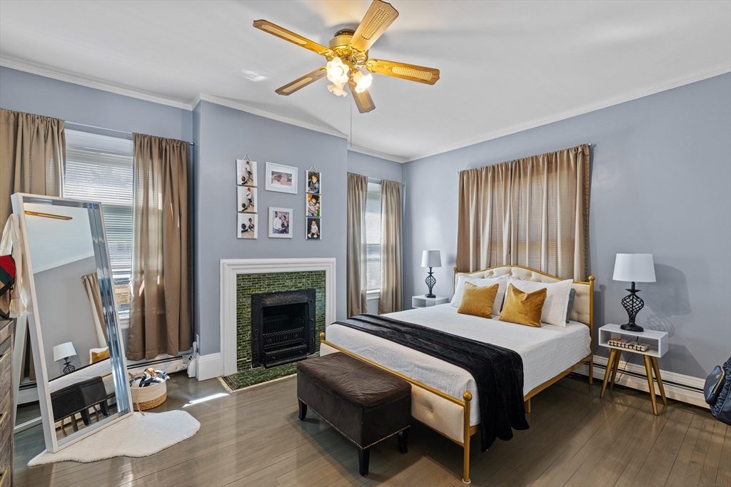 499 Madison Street Fall River, MA 02720 - Photo 23 of 38 a bedroom with a bed fireplace and a window