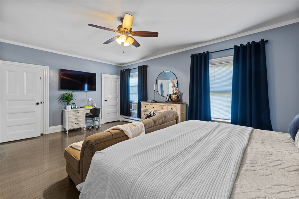 499 Madison Street Fall River, MA 02720 - Photo 24 of 38 a bedroom with a bed and a chandelier