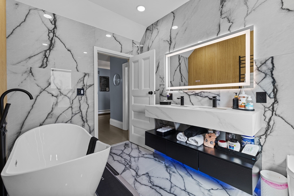 499 Madison Street Fall River, MA 02720 - Photo 29 of 38 a bathroom with a bathtub sink and mirror