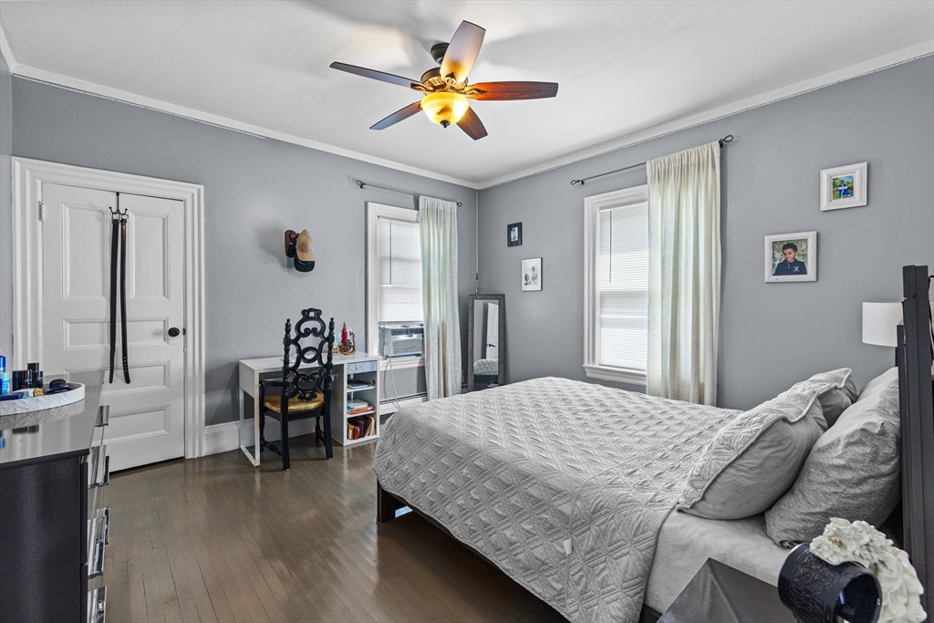 499 Madison Street Fall River, MA 02720 - Photo 30 of 38 a bedroom with a bed and a chandelier