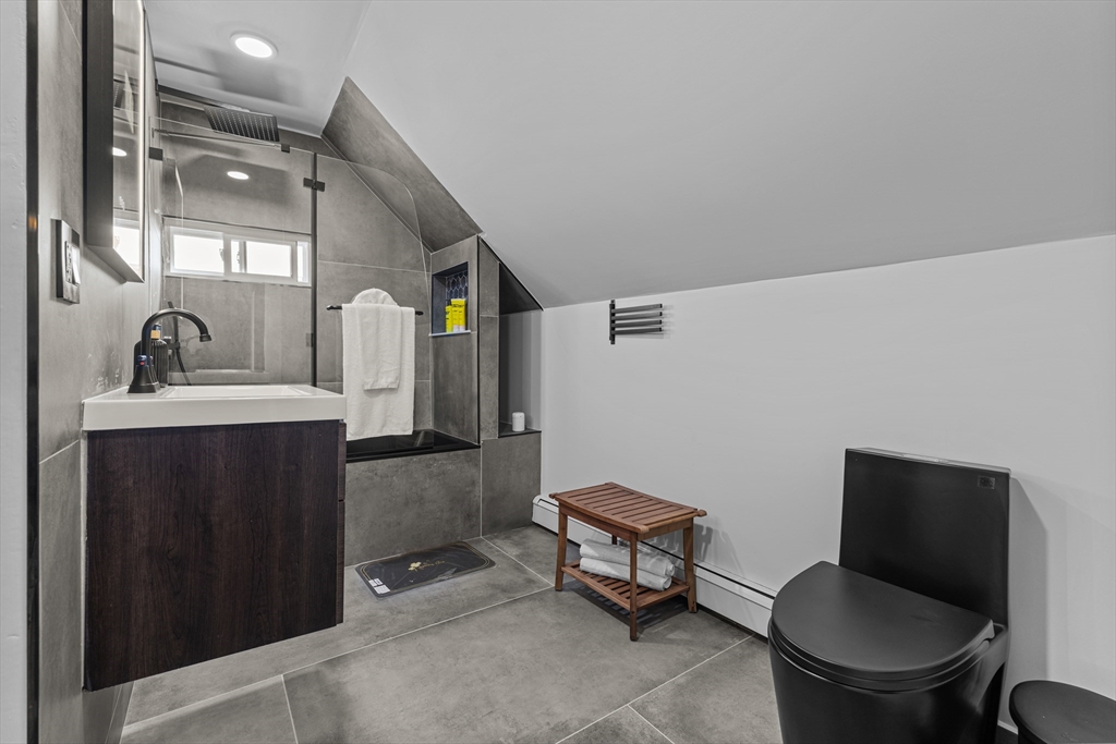 499 Madison Street Fall River, MA 02720 - Photo 37 of 38 a bathroom with a toilet a sink and mirror