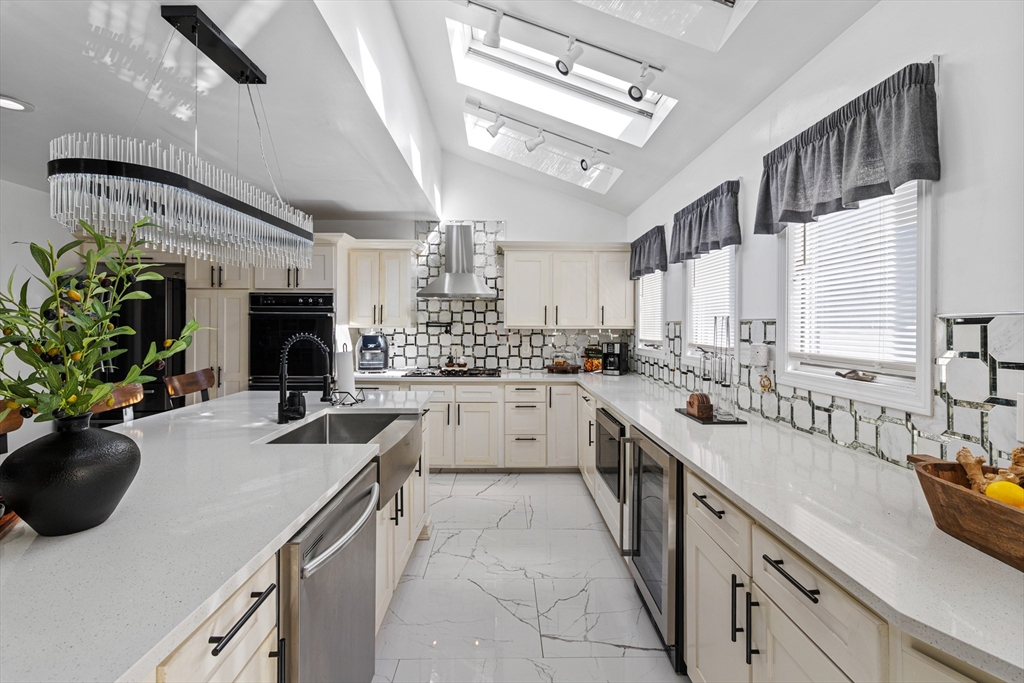 499 Madison Street Fall River, MA 02720 - Photo 8 of 38 a kitchen with a sink stove and cabinets
