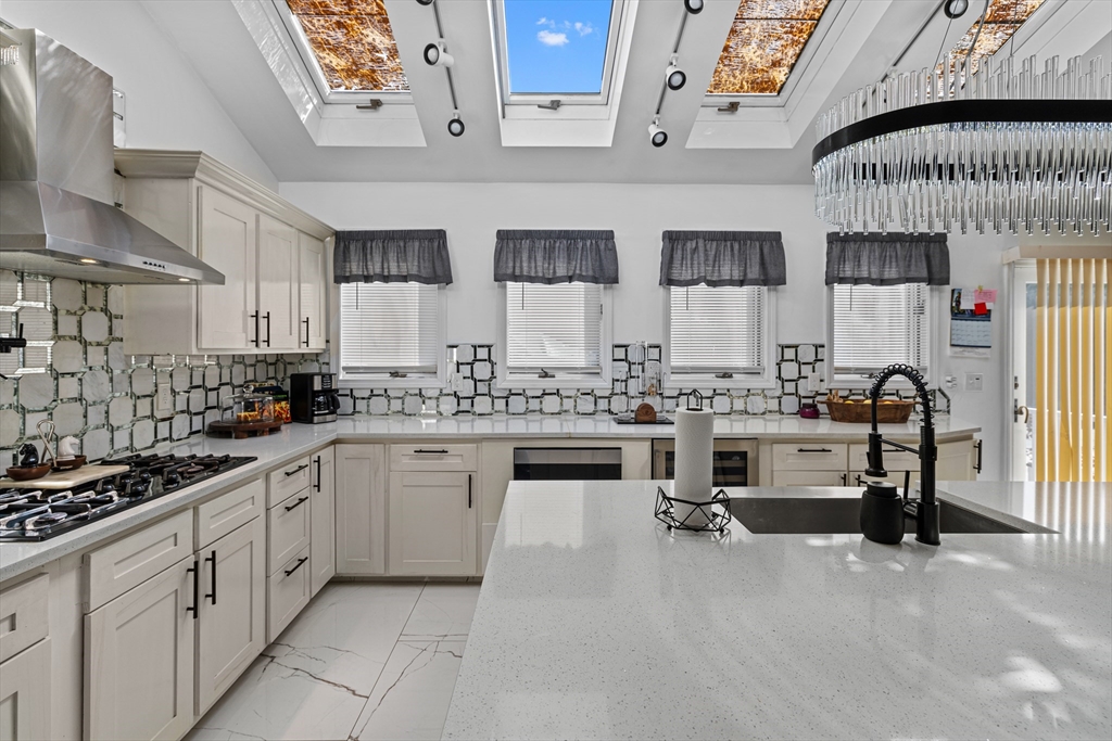 499 Madison Street Fall River, MA 02720 - Photo 9 of 38 a kitchen with white cabinets and sink