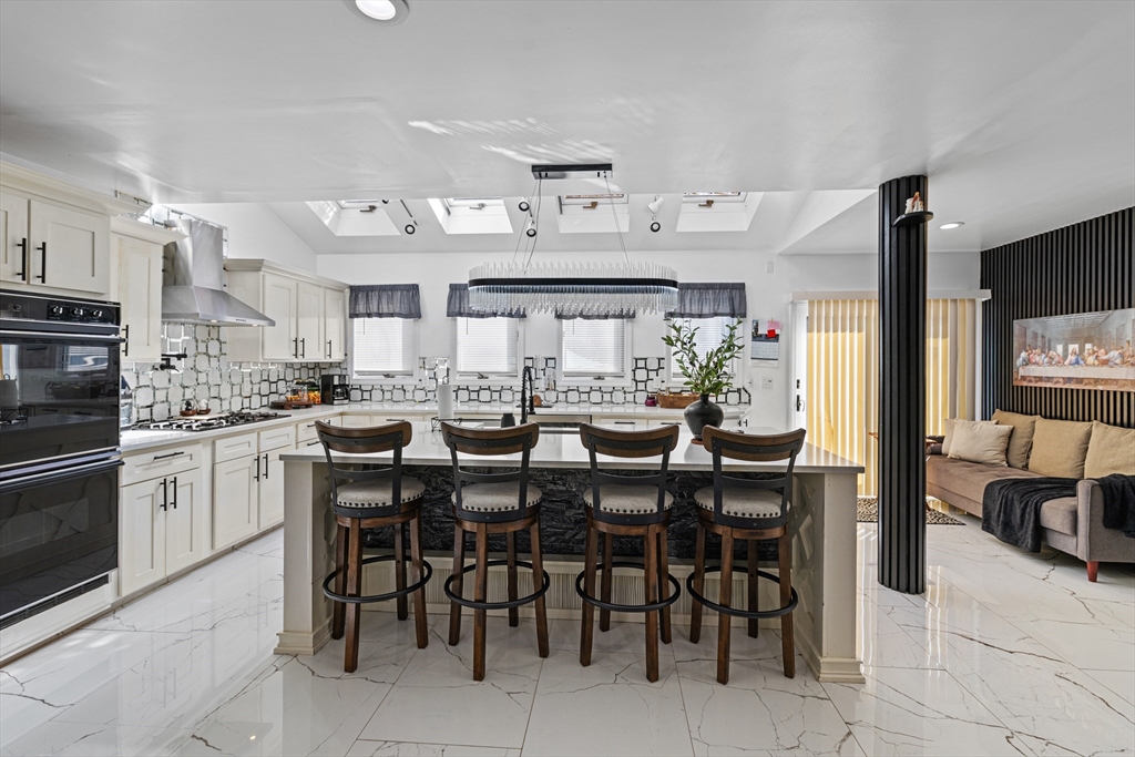 499 Madison Street Fall River, MA 02720 - Photo 10 of 38 a kitchen with cabinets and chairs