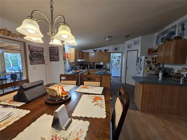 a room with stainless steel appliances kitchen island granite countertop furniture and a kitchen view