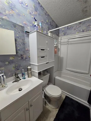 a bedroom with bed and wooden floor