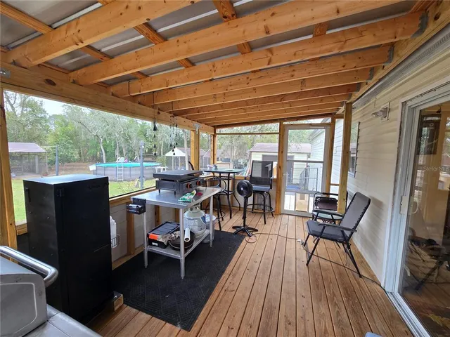 a view of a patio with table and chairs