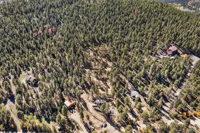 a view of a dry yard with wooden fence