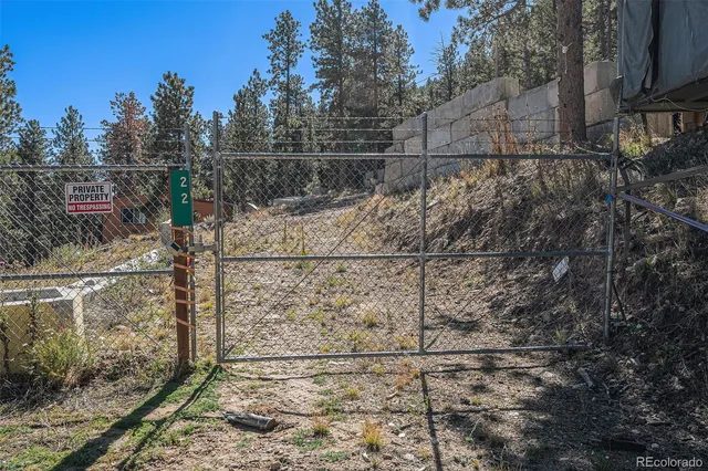 a view of a dirt road with a building in the background