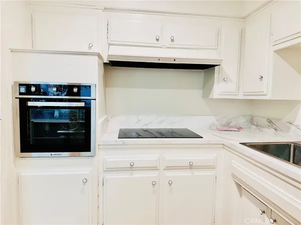 a kitchen with cabinets appliances and a sink