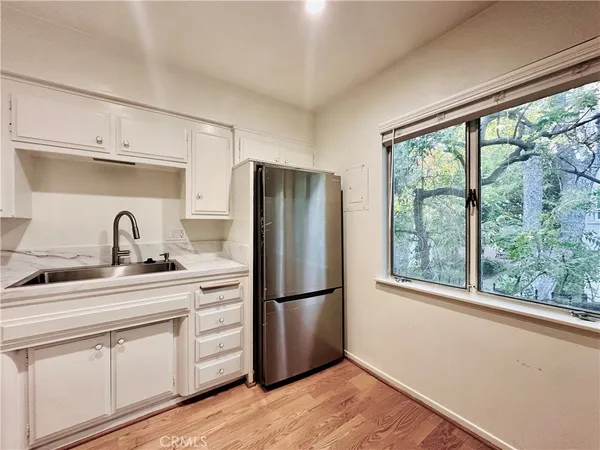 a kitchen with appliances cabinets a sink and a window