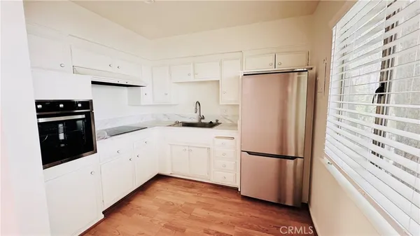 a kitchen with a refrigerator and a stove