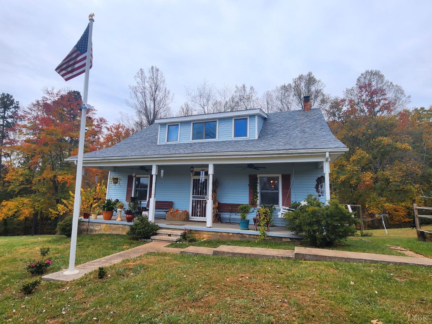 a view of a house with backyard porch and furniture