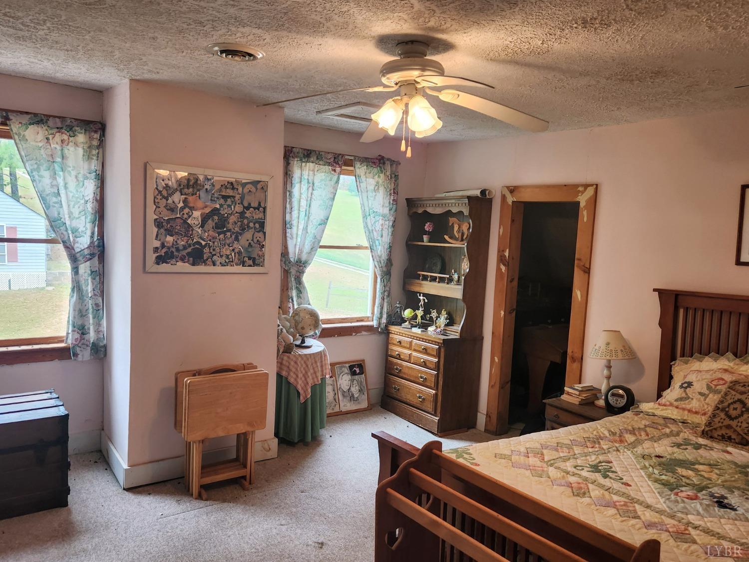 159 Buck Hill Drive Amherst, VA 24521 - Photo 15 of 31 a bedroom with a bed and a chandelier