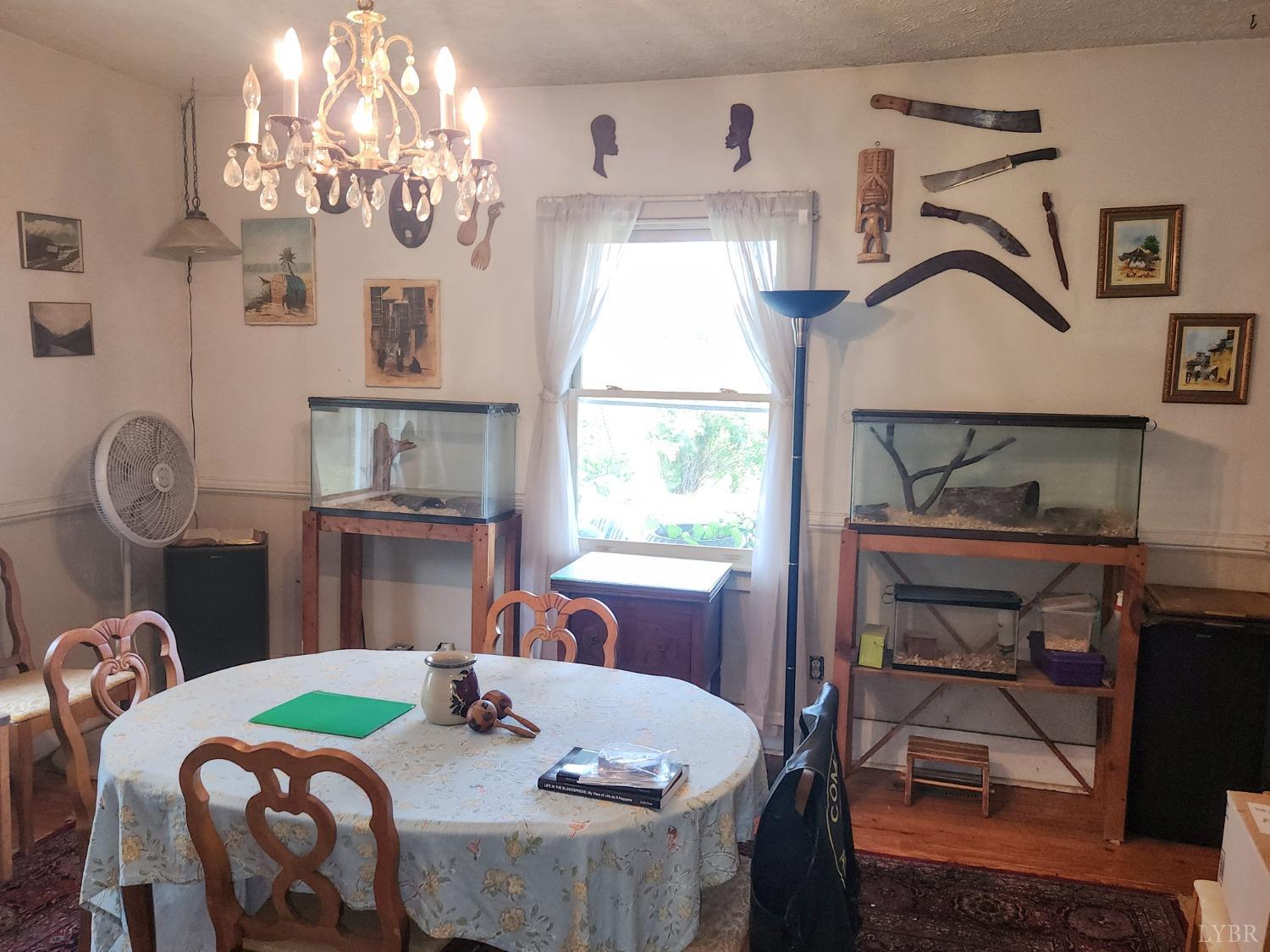 159 Buck Hill Drive Amherst, VA 24521 - Photo 20 of 31 a dining room with furniture a chandelier and window
