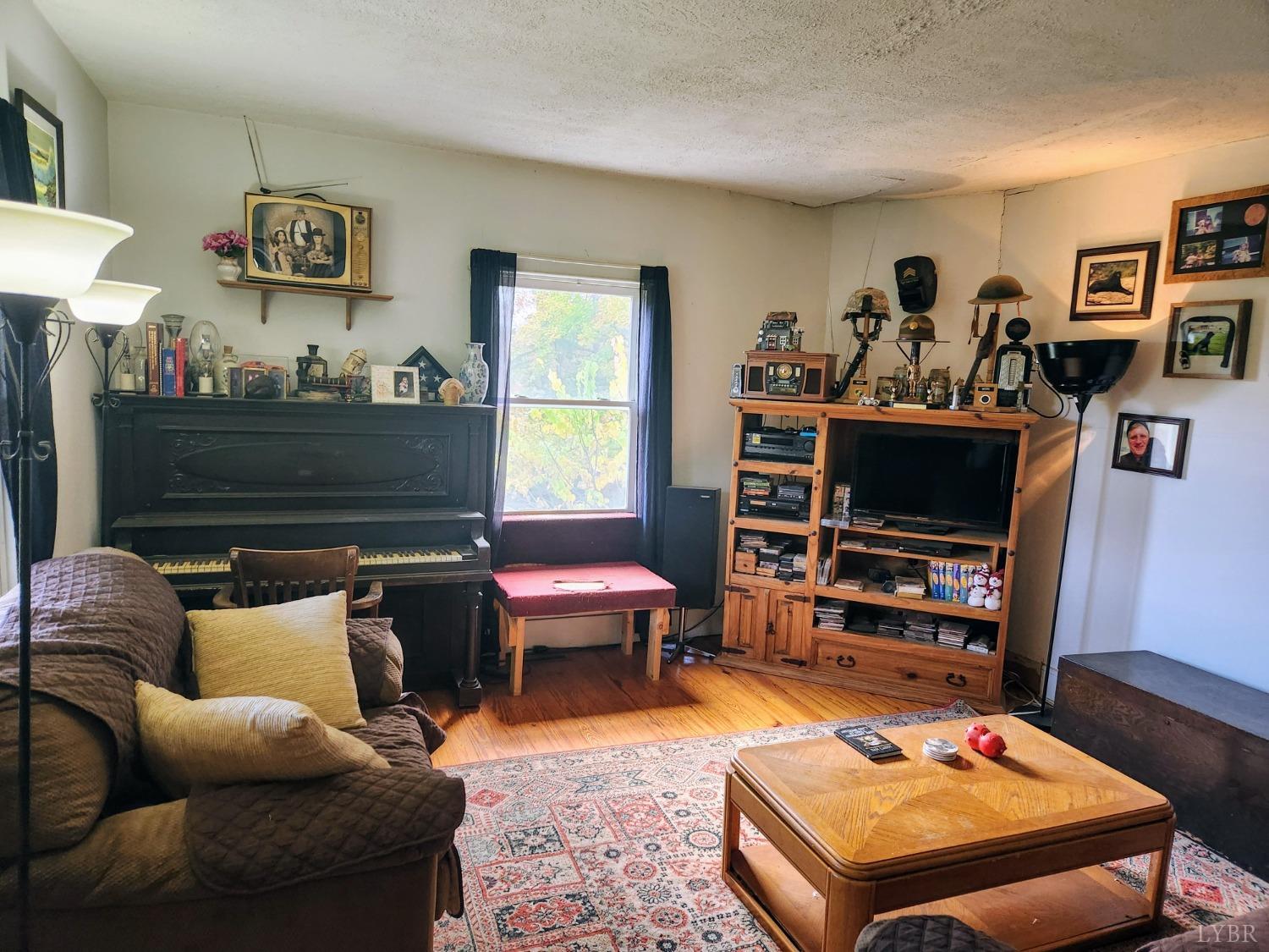 159 Buck Hill Drive Amherst, VA 24521 - Photo 23 of 31 a living room with furniture and a flat screen tv