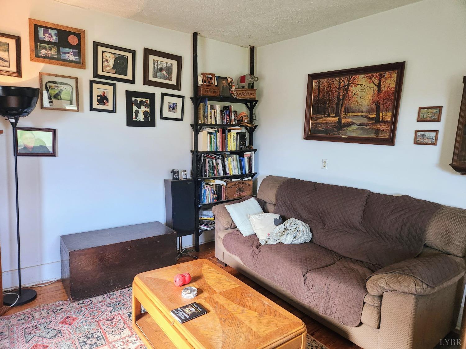 159 Buck Hill Drive Amherst, VA 24521 - Photo 24 of 31 a living room with furniture and a book shelf