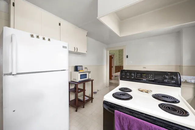 a kitchen with a refrigerator and a stove