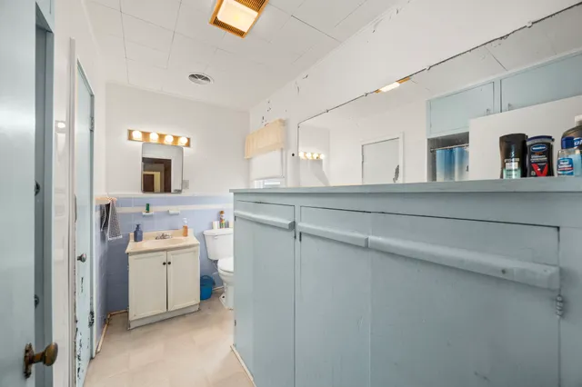 a utility room with cabinets washer and dryer