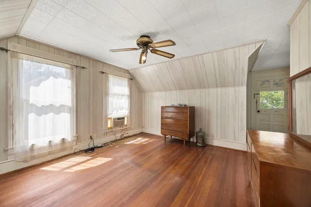 a view of a livingroom with furniture and a window