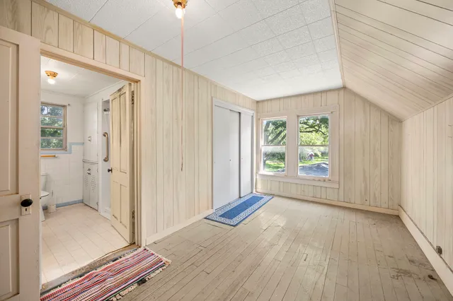 a view of a livingroom with wooden floor and windows
