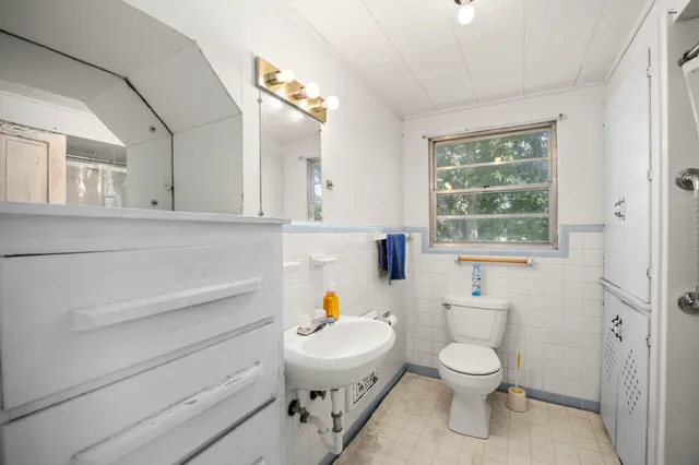 a white toilet sitting next to a bathroom sink