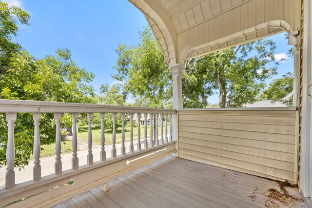 a view of a balcony with wooden floor and outdoor space