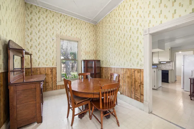 a view of a dining room with furniture and a window