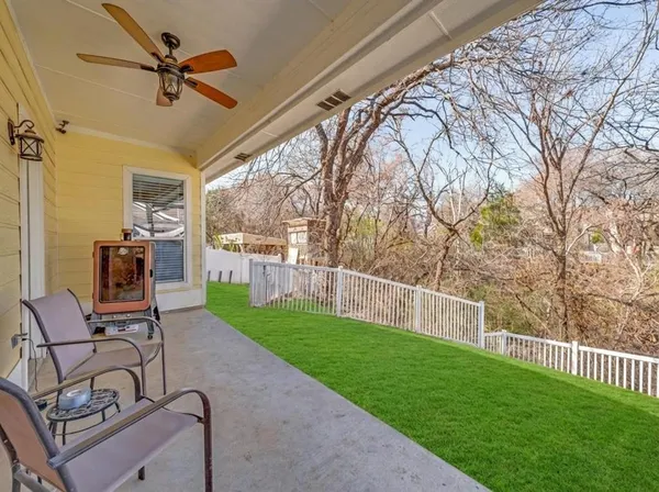 a view of a porch with furniture and a yard