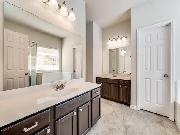 a en suite bathroom with a sink double vanity and a mirror
