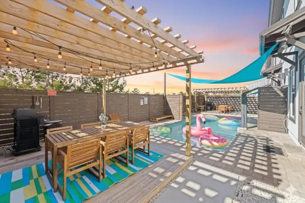 a view of a patio with table and chairs potted plants