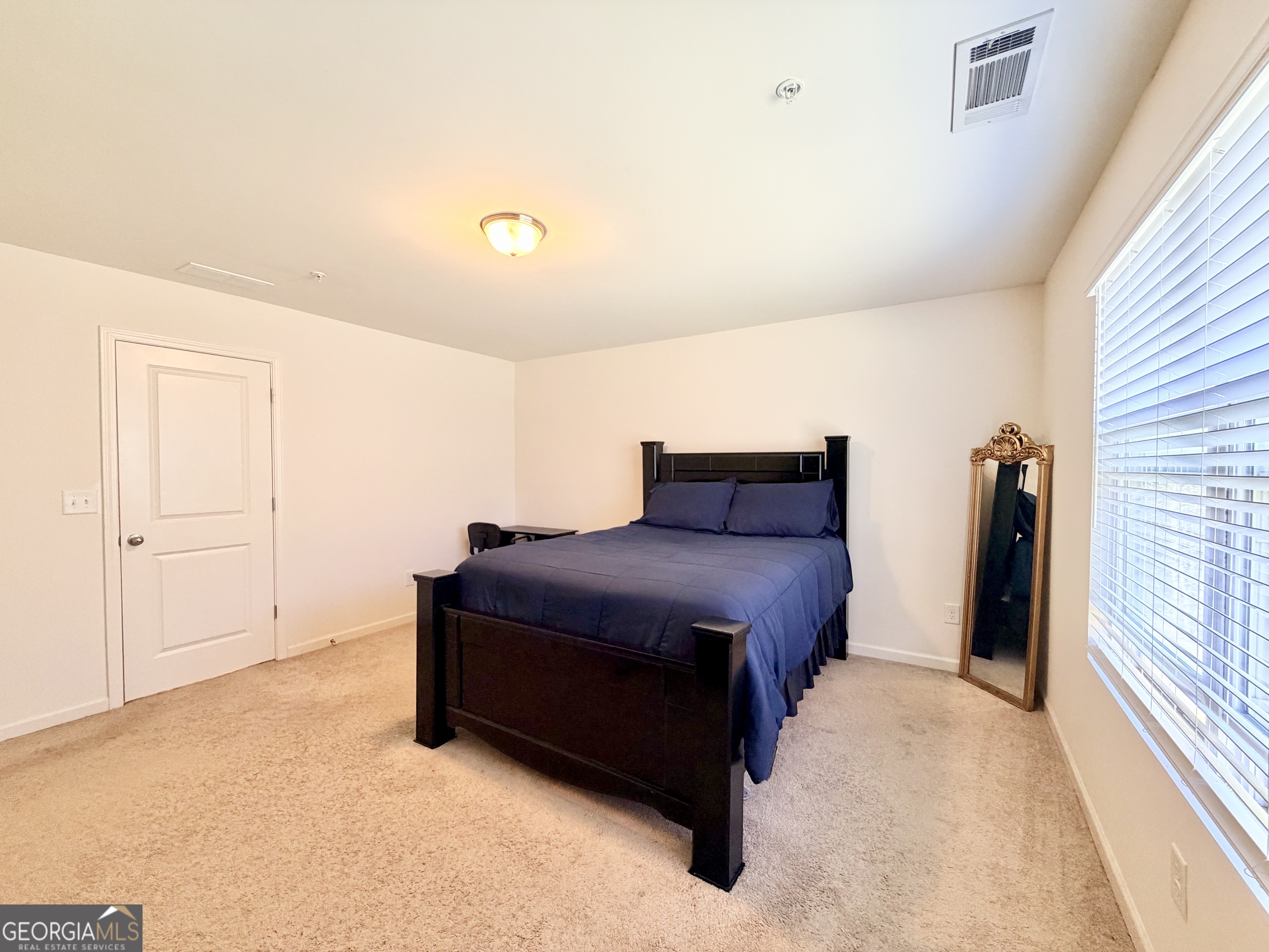 1601 Honeysuckle Path Conyers, GA 30012 - Photo 23 of 34 a bedroom with a bed and a large window