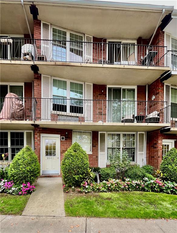 9965 Shore Road, Unit 6C Brooklyn, NY 11209 - Photo 1 of 37 front view of a building and a yard