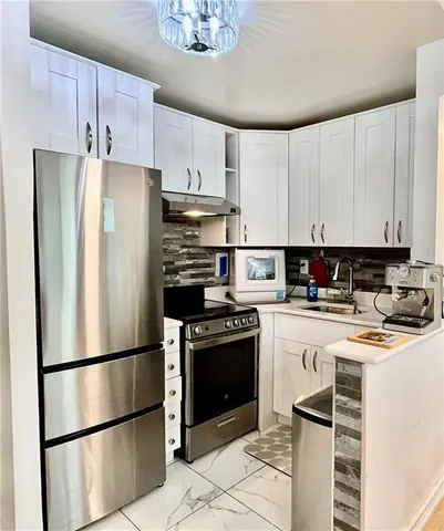 a kitchen with stainless steel appliances granite countertop a refrigerator sink and cabinets