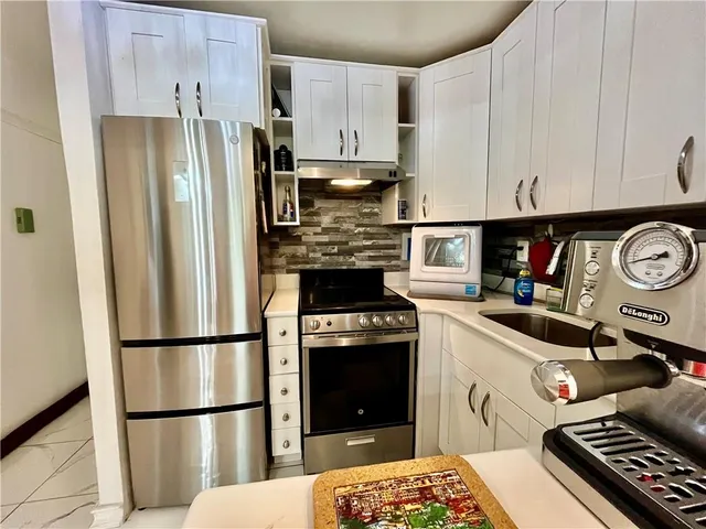 a kitchen with a refrigerator sink and stove
