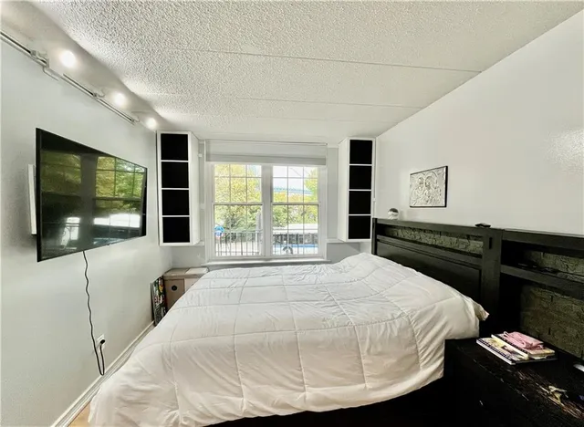 a bedroom with a bed and a flat screen tv