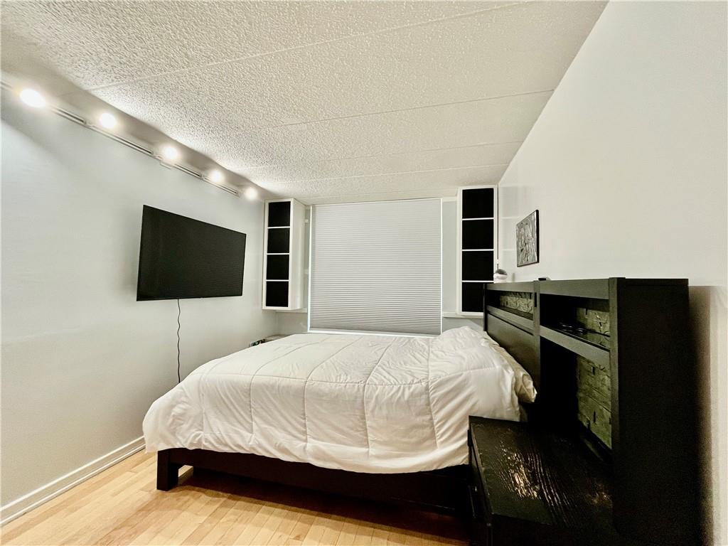 9965 Shore Road, Unit 6C Brooklyn, NY 11209 - Photo 23 of 37 a bedroom with a bed and a flat screen tv