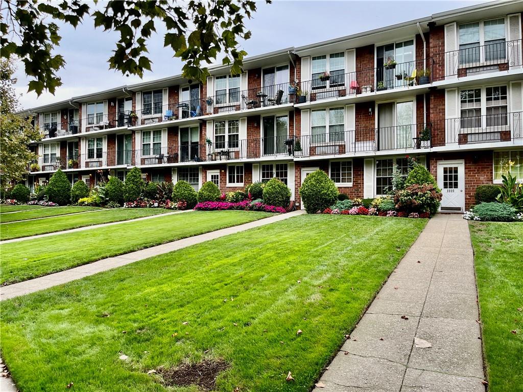 9965 Shore Road, Unit 6C Brooklyn, NY 11209 - Photo 35 of 37 a front view of building with yard