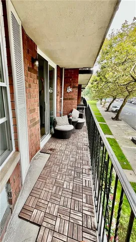 a living room with furniture a flat screen tv and a floor to ceiling window