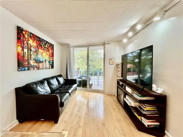 a view of a dining room with furniture a livingroom and wooden floor