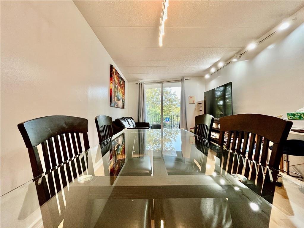 9965 Shore Road, Unit 6C Brooklyn, NY 11209 - Photo 8 of 37 a view of a dining room with furniture a livingroom and wooden floor