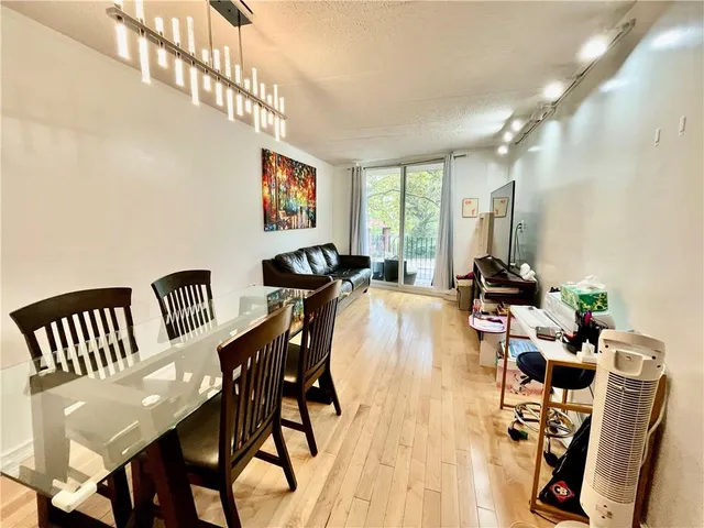 a view of a a dining room with furniture window and wooden floor