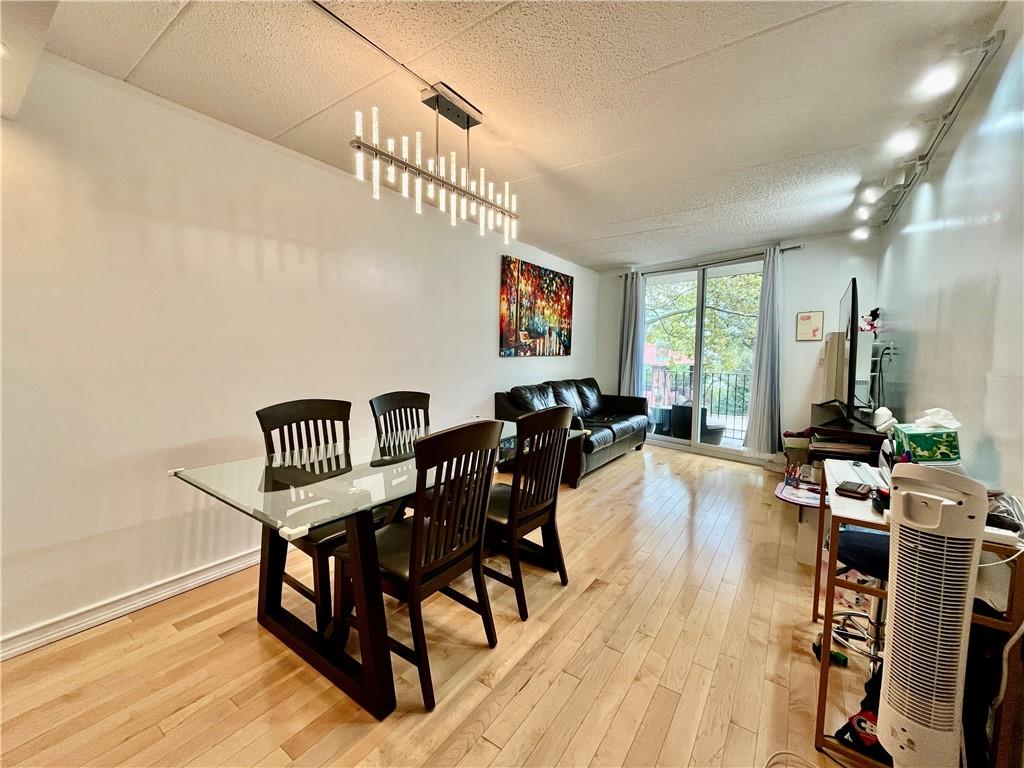 9965 Shore Road, Unit 6C Brooklyn, NY 11209 - Photo 10 of 37 a view of a a dining room with furniture window and wooden floor