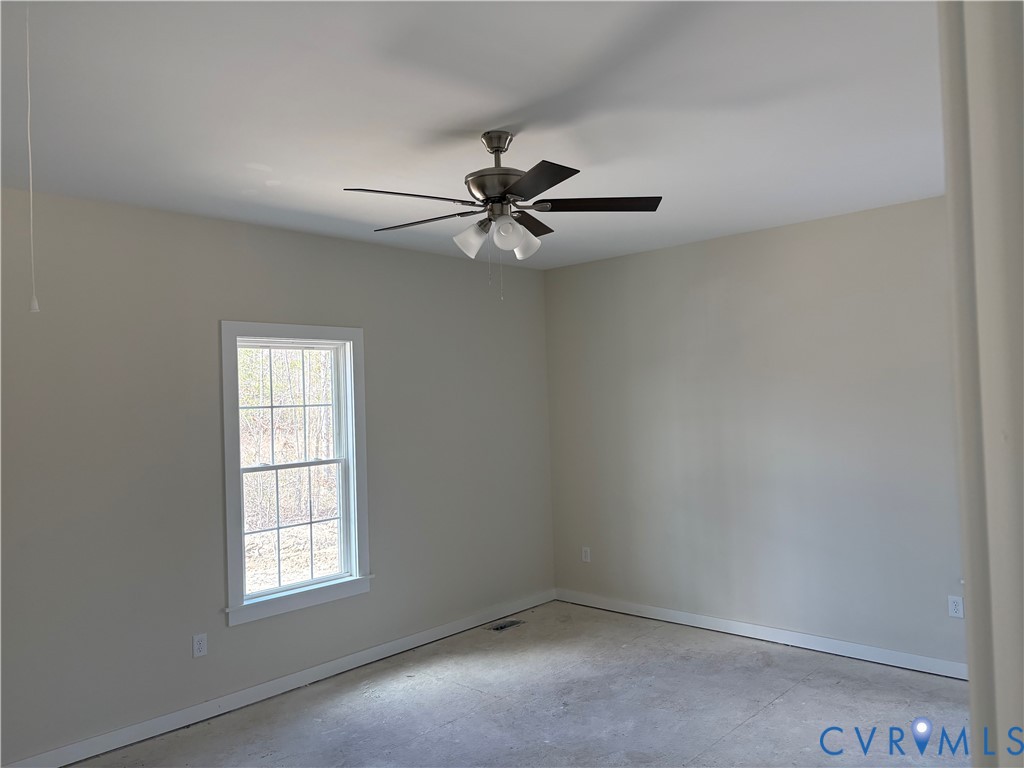 15085 Lebanon Road Disputanta, VA 23842 - Photo 14 of 17 an empty room with windows and fan