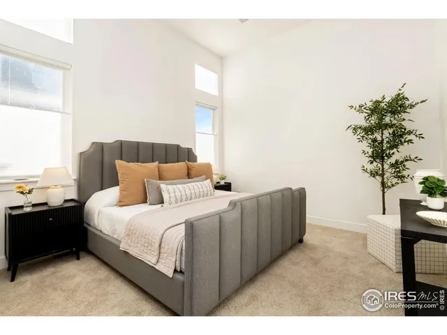 a bedroom with a bed and a potted plant