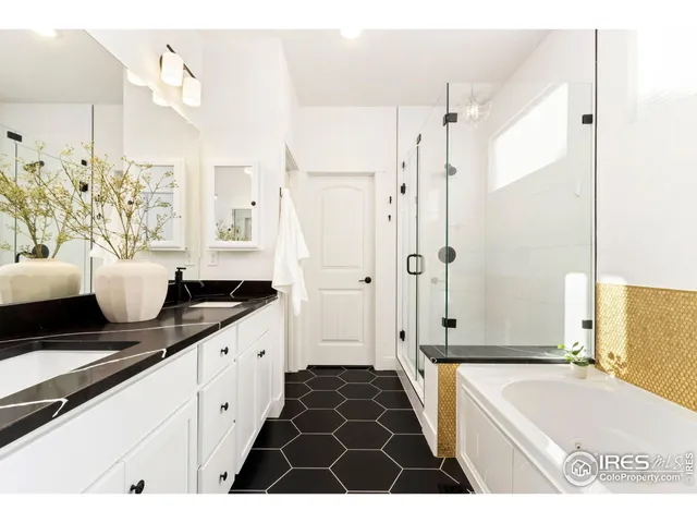 a spacious bathroom with a granite countertop tub shower and a sink