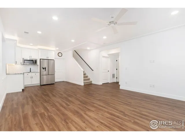 a view of a kitchen with a sink and a refrigerator