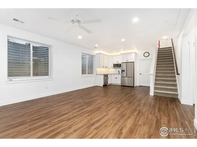 a view of a kitchen with furniture and wooden floor